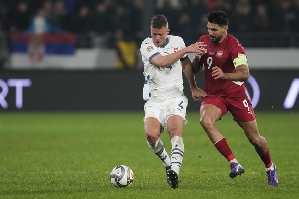 Switzerland&#039;s Nico Elvedi, left, and Serbia&#039;s Aleksandar Mitrovic fight for the ball during the UEFA Nations League soccer match between Serbia and Switzerland at the Dubocica Stadium in Les ...