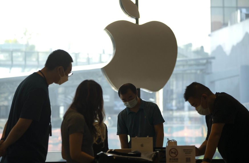 Customers shop at an Apple Store on the first day of sale for the Apple iPhone 14 in Beijing, China, Friday, Sept. 16, 2022. (AP Photo/Mark Schiefelbein)