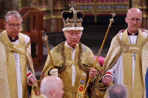 LONDON, ENGLAND - MAY 06: King Charles III stands after being crowned during his coronation ceremony in Westminster Abbey, on May 6, 2023 in London, England. The Coronation of Charles III and his wife ...
