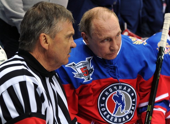 epa05298309 International Ice Hockey Federation (IIHF) President Rene Fasel (L) and Russian President Vladimir Putin (R) speak during a gala match of the Night Hockey League at the Bolshoi Ice Arena i ...