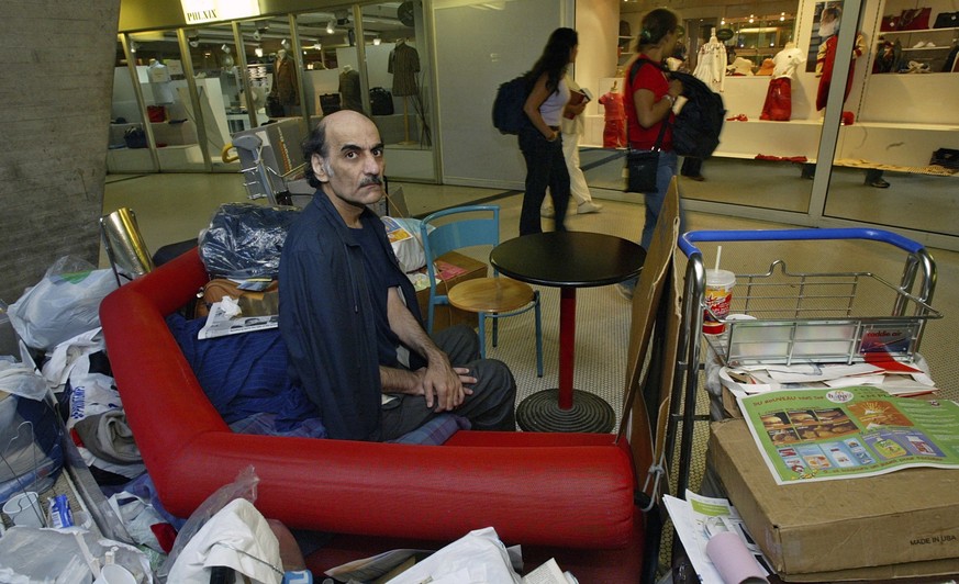 FILE - Merhan Karimi Nasseri sits among his belongings at Terminal 1 of Roissy Charles De Gaulle Airport, north of Paris on Aug. 11, 2004 . An Iranian man who lived for 18 years in Paris&#039; Charles ...