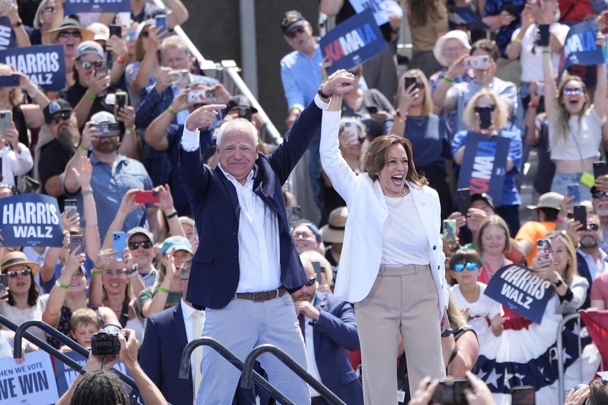 Democratic presidential nominee Vice President Kamala Harris is welcomed by Democratic vice presidential nominee Minnesota Gov. Tim Walz, before she delivers remarks at a campaign event, Wednesday, Au ...