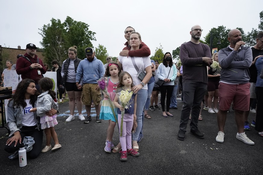 The Galbano family, from Highland Park, Ill., center, listens during a vigil in Highwood, Ill., for the victims of Monday&#039;s Highland Park&#039;s Fourth of July parade, Wednesday, July 6, 2022. (A ...