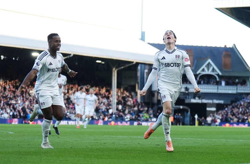 Fulham's Harry Wilson, right, celebrates scoring their side's second goal of the game during the Premier League match between Fulham and Burnley, in London, Saturday March 21, 2026. (John Wa ...