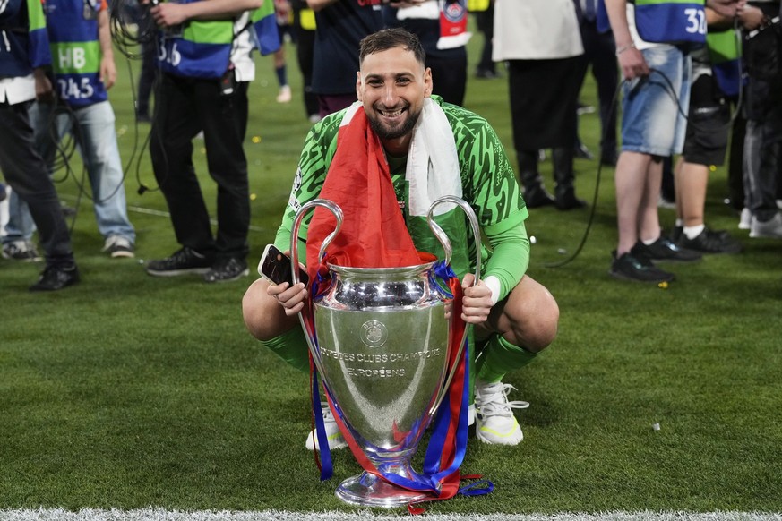 PSG&#039;s goalkeeper Gianluigi Donnarumma poses with the trophy after winning the Champions League final soccer match between Paris Saint-Germain and Inter Milan at the Allianz Arena in Munich, Germa ...