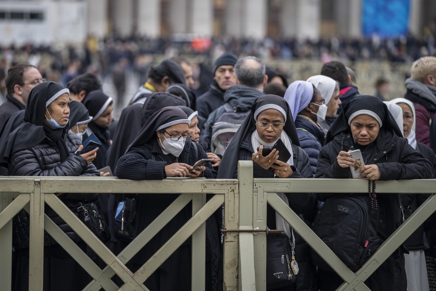 Nuns wait in line to view the body of Pope Emeritus Benedict XVI as it lies in state in St. Peter&#039;s Basilica at the Vatican, Monday, Jan. 2, 2023. The Vatican announced that Pope Benedict died on ...