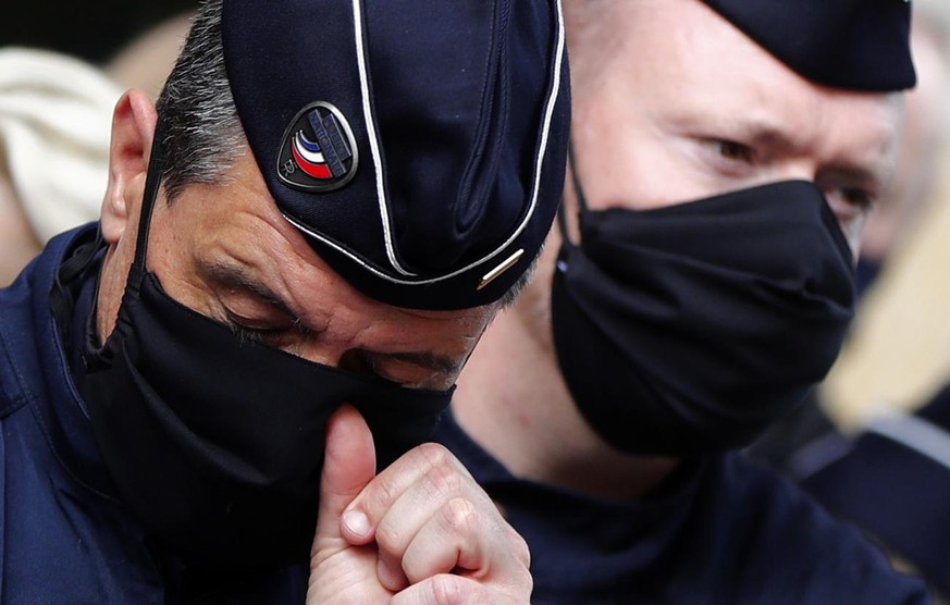 epa09162126 Police officers stand in front of the police station in Montpellier, France, 26 April 2021, during a tribute to a police officer Stephanie M. stabbed to death on 23 April, in Rambouillet,  ...