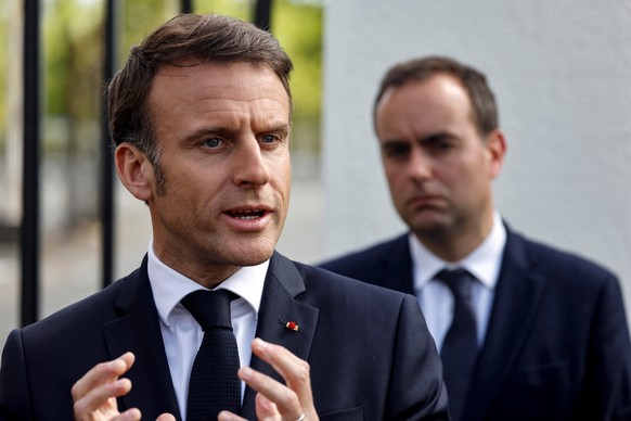 epa11272773 France&#039;s President Emmanuel Macron (L) addresses the media as France&#039;s Minister for the Armed Forces Sebastien Lecornu (R) listens during a visit to the powders and explosives co ...