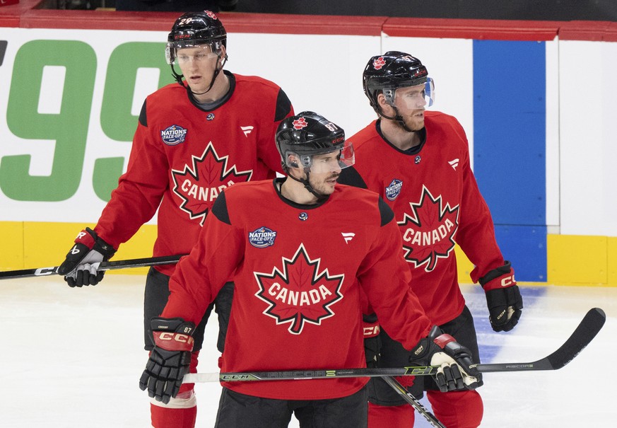 Canada's Sidney Crosby (87), Connor McDavid (97) and Nathan MacKinnon (29) watch during practice for the 4 Nations Face-Off hockey tournament in Montreal, Tuesday, Feb. 11, 2025. (Christinne Musc ...