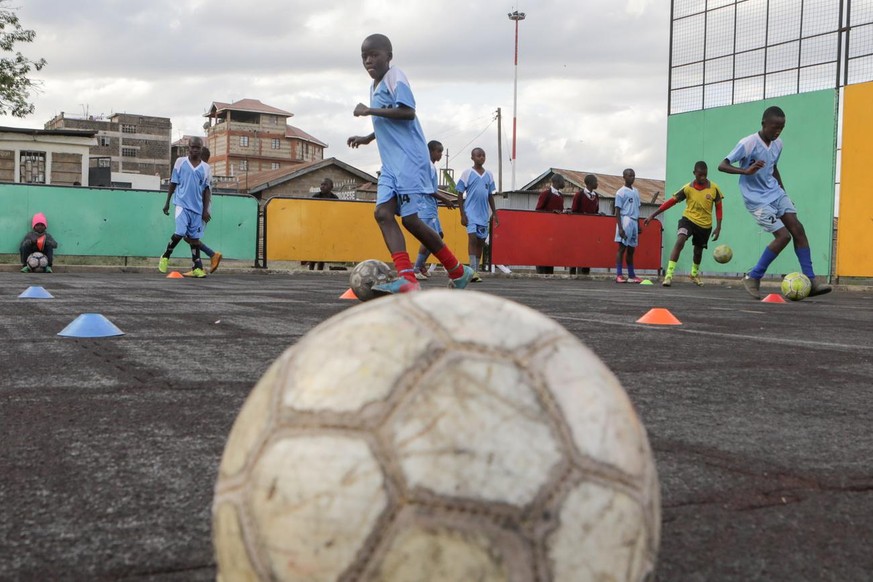 epa07021647 Soccer players from the Acakoro Football Academy Under 15 team warm up during a training session at the academy&#039;s training pitch after coming from school near Korogocho slum in Nairob ...