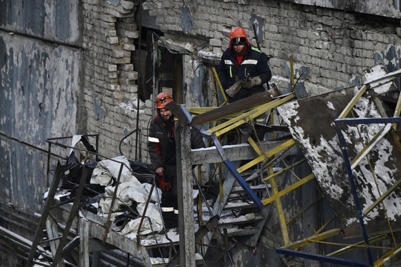 Employees clear debris at a heavily damaged thermal power plant of the Ukrainian energy provider DTEK in an undisclosed location in Ukraine on February 9, 2026, following Russian missile and drone str ...