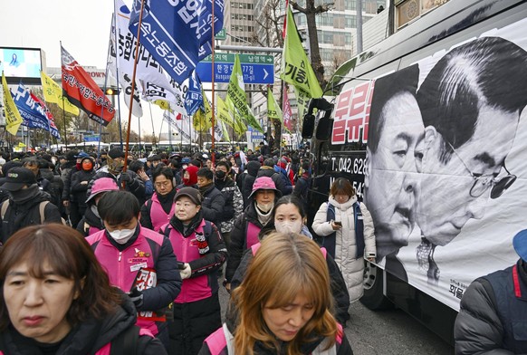 Rally against S. Korea s Yoon People call for South Korean President Yoon Suk Yeol s impeachment while marching in Seoul on Dec. 12, 2024, as the president defends his short-lived martial law decree i ...