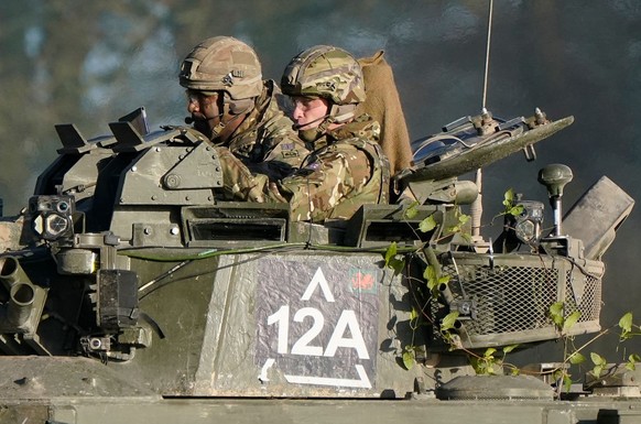 SALISBURY, ENGLAND - NOVEMBER 23: Prince William, Prince of Wales, Colonel-in-Chief, 1st Battalion Mercian Regiment (L) listens to a briefing ahead of an attack exercise during a visit to the regiment ...