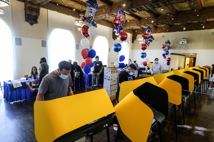 Voters cast their ballots for the California recall election at a vote center at City Hall in Beverly Hills, Calif., on Tuesday, Sept. 14, 2021. (AP Photo/Ringo H.W. Chiu)