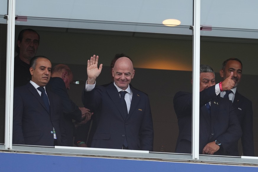 FIFA President Gianni Infantino, center, waves from the tribune during the World Cup Group J soccer match between Argentina and Algeria in Kansas City, Mo., Tuesday, June 16, 2026. (AP Photo/Ed Zurga) ...