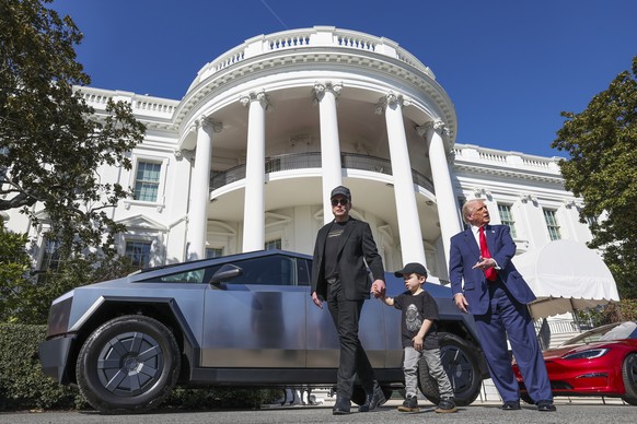 President Donald Trump and Tesla CEO Elon Musk, along with his son X � A-Xii, speak to reporters near Tesla vehicles on South Lawn of the White House Tuesday, March 11, 2025, in Washington. (Pool via  ...
