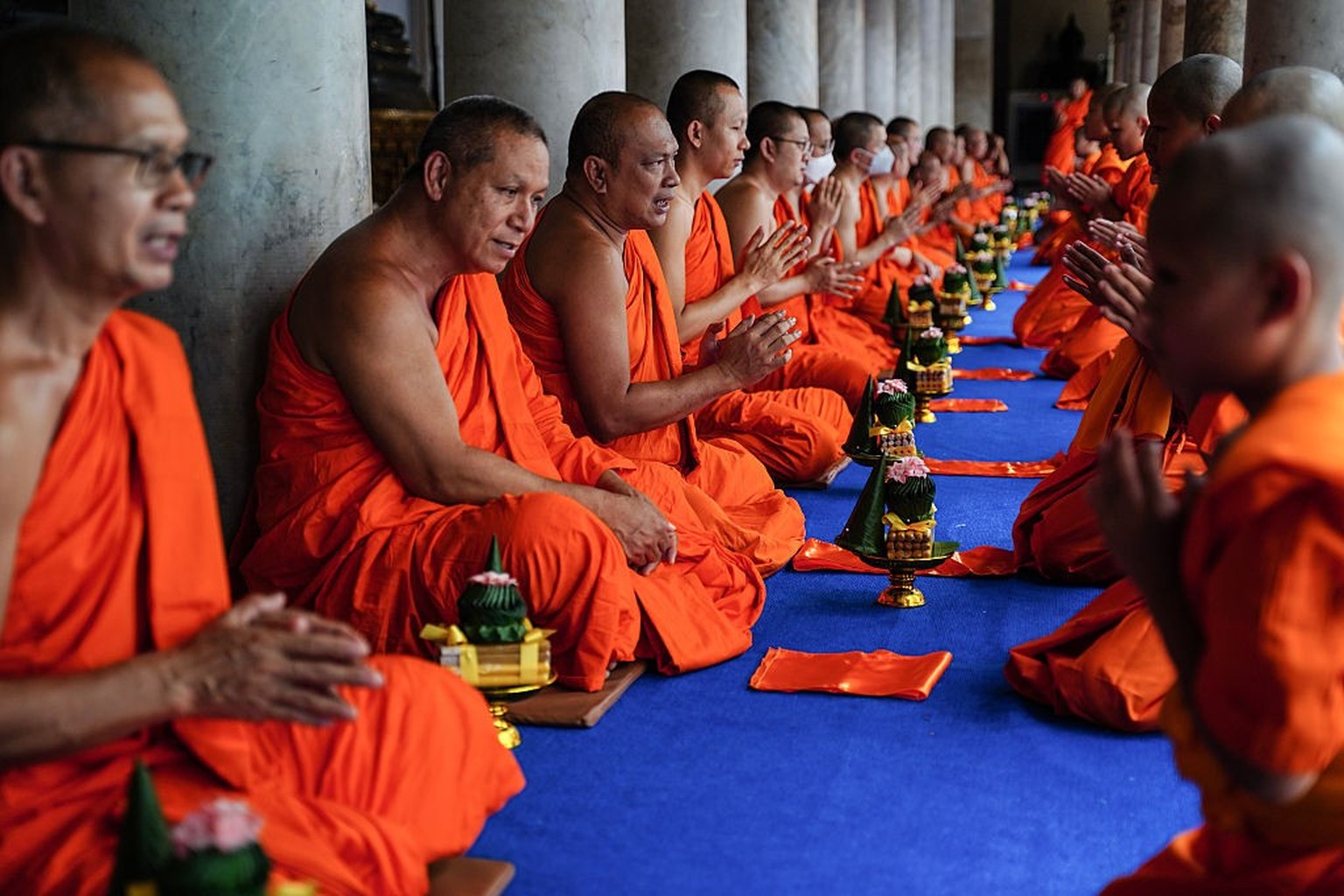Newly ordained hill tribe Buddhist monks pay respects after receiving the precepts from senior monks during a mass Buddhist monk ordination ceremony for hill tribe men at Wat Benchamabophit, also know ...