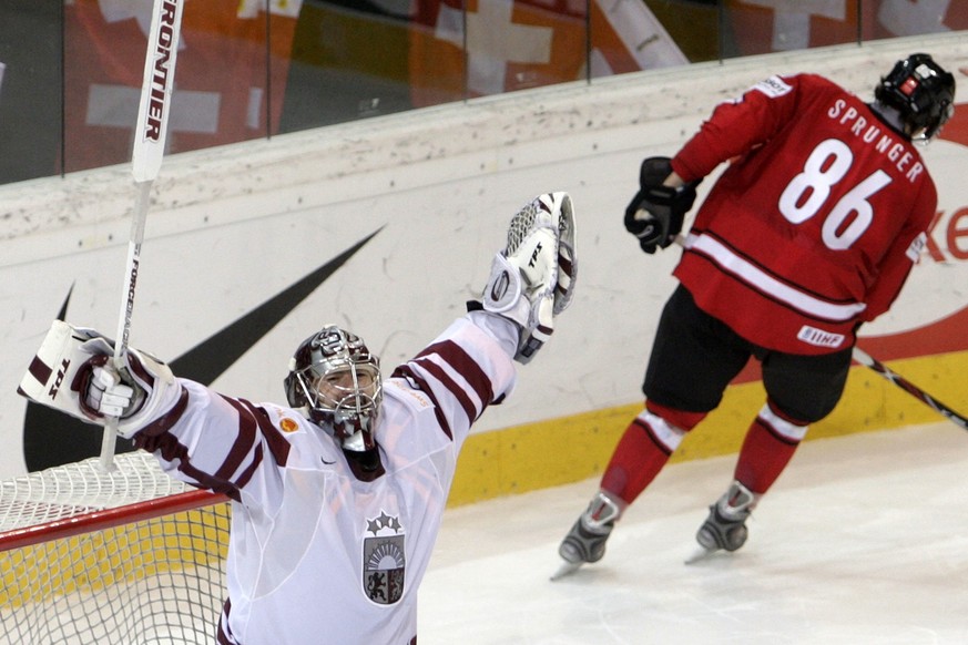 Latvia's goalkeeper Edgars Masalskis, left, jubilates after Switzerland's Julien Sprunger, right, missed his penalty, in the Group E Qualifying Round game between Switzerland and Latvia at t ...