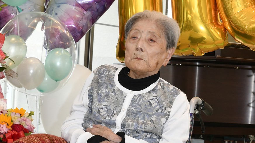 FILE - This photo provided by Ashiya City shows Tomiko Itooka, being celebrated for her 116th birthday at the nursing home she lives in Ashiya, western Japan, on May 23, 2024. (Ashiya City via AP, Fil ...