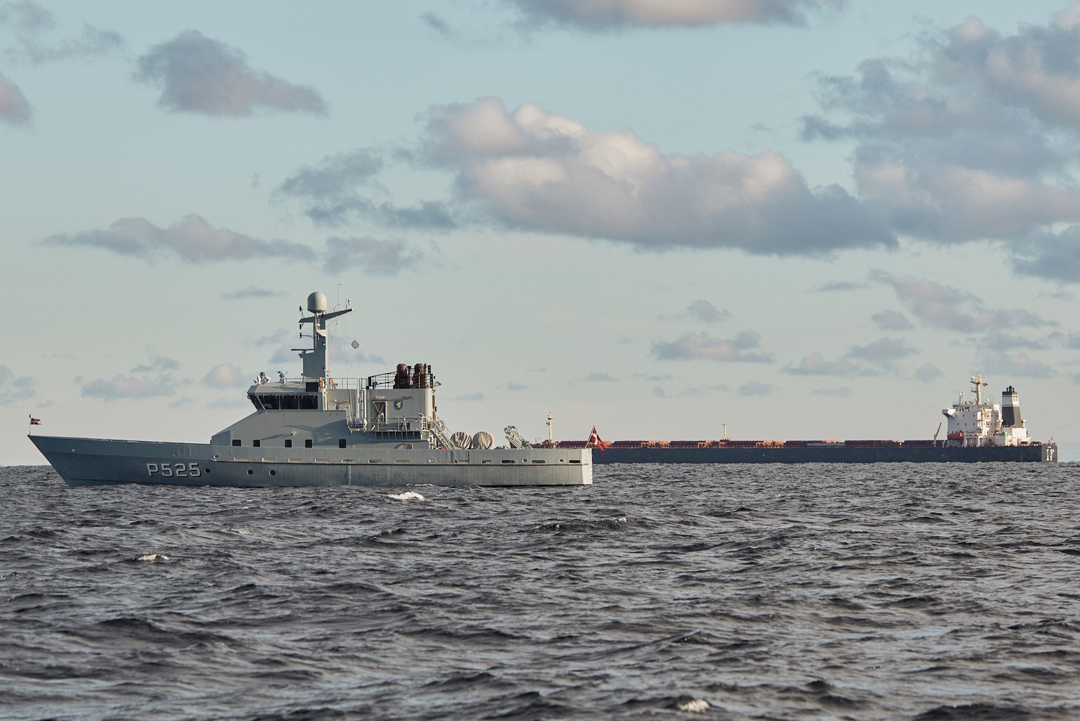 The Chinese ship, the bulk carrier Yi Peng 3, in background, is anchored and being monitored by a Danish naval patrol vessels in the sea of Kattegat, near the city of Granaa in Jutland, Denmark, Wedne ...