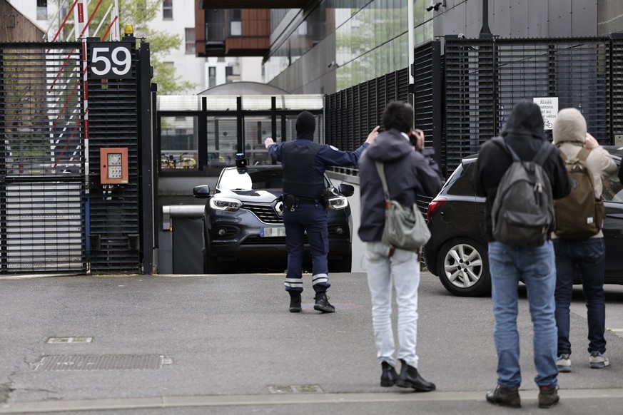A customs officer leads the way out of a car leaving the Office national antifraude (ONAF, National Anti-fraud Office) building where Congolese singer, rapper, and singer-songwriter GIMS, formerly kno ...