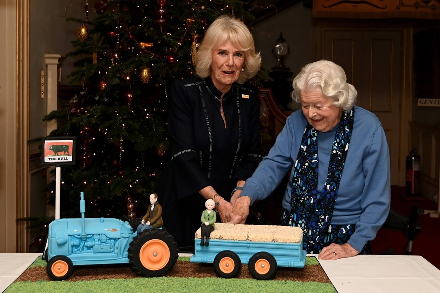 07/12/2021. London, United Kingdom. Camilla, Duchess of Cornwall and actress June Spencer cut an Archers themed cake during a celebration for the 70th anniversary of the radio programme The Archers, a ...