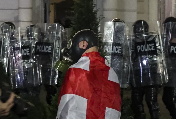 epa12430611 Georgian opposition parties supporters clash with riot police during a rally after local elections in Tbilisi, Georgia, 04 October 2025. Elections to local governments are held in Georgia  ...