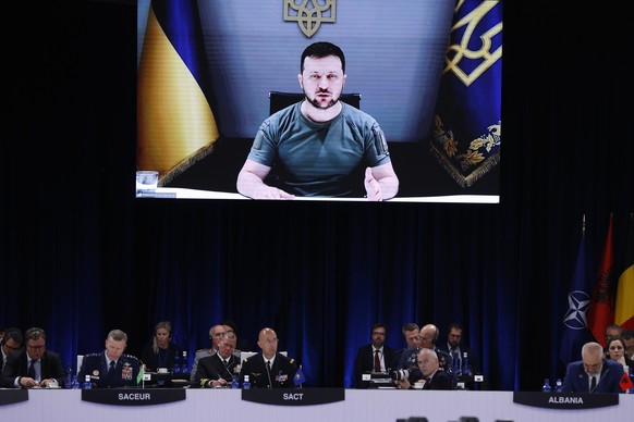 epa10134565 (FILE) - Ukrainian President Volodymyr Zelensky (on the screen), delivers a speech as he attends by video conference a meeting during the first day of the NATO Summit at IFEMA Convention C ...