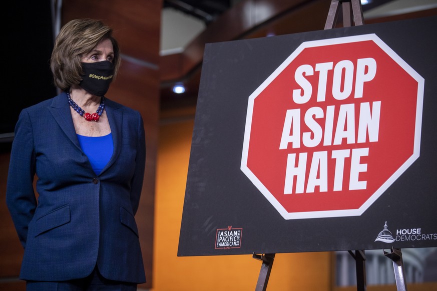 epa09208926 Speaker of the House Nancy Pelosi listens to remarks during a press conference about the COVID-19 Hate Crimes Act in the US Capitol in Washington, DC, USA, 18 May 2021. The House is expect ...