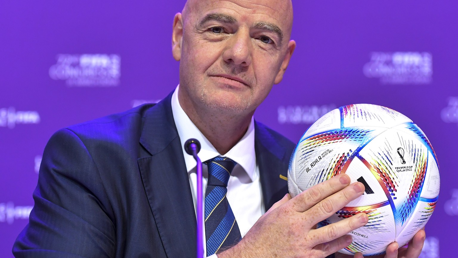 epa09861814 FIFA president Gianni Infantino poses with the official World Cup 2022 matchball Al Rihla before the closing press conference of the 72nd FIFA Congress in Doha, Qatar, 31 March 2022. EPA/N ...