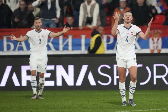 Switzerland&#039;s Silvan Widmer, left, and Nico Elvedi react during the UEFA Nations League soccer match between Serbia and Switzerland at the Dubocica Stadium in Leskovac, Serbia, Saturday, Oct. 12, ...