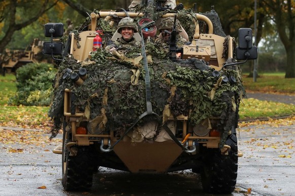 DEREHAM, ENGLAND - NOVEMBER 8: Catherine, Princess of Wales drives an armoured vehicle as she visits The Queen's Dragoon Guards Regiment for the first time as their Colonel in Chief on November 8 ...