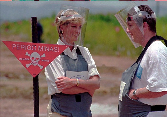 epa12333135 (FILE) - Britain's Princess Diana, wearing a heavy duty protection vest and face shield, accompanied by a mine clearing expert of the Halo Trust during her visit to the minefields in  ...