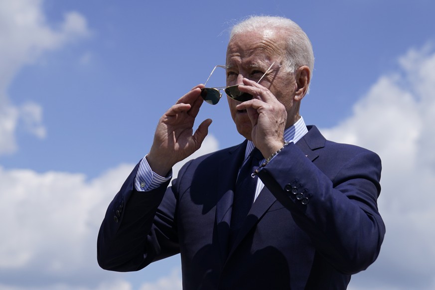 President Joe Biden puts on his sunglasses after speaking to members of the media before boarding Air Force One for a trip to Cleveland, Thursday, May 27, 2021, in Andrews Air Force Base, Md. (AP Phot ...