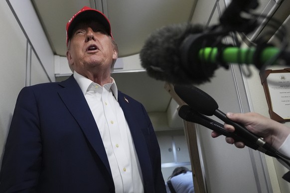 President Donald Trump speaks to reporters on board Air Force One, en route from Joint Base Andrews, Md., to Morristown Municipal Airport in Morristown, N.J., Friday, July 4, 2025. (AP Photo/Jacquelyn ...