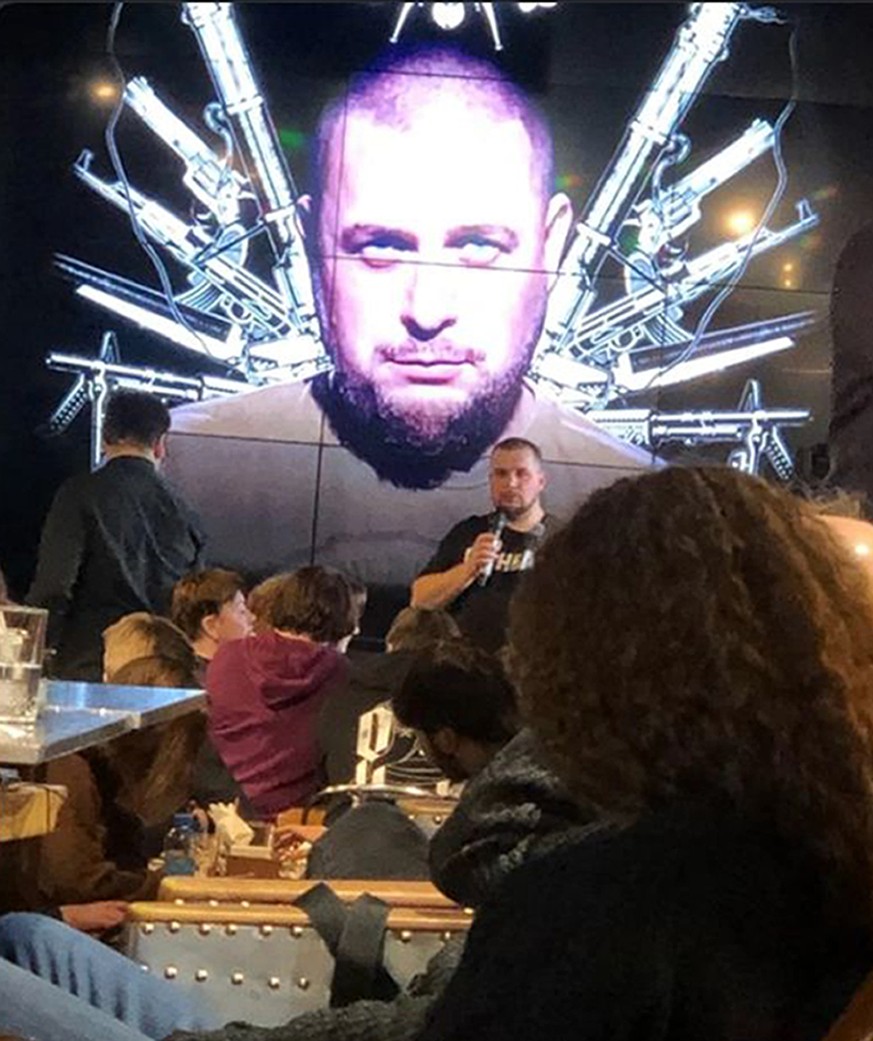 Russian blogger Vladlen Tatarsky speaks during a party in front of projection of an image of him, before an explosion at a cafe in St. Petersburg, Russia, Sunday, April 2, 2023. An explosion tore thro ...