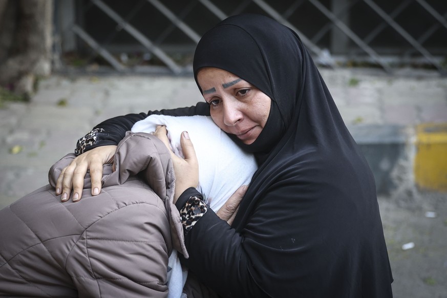 epa11777824 Two women react after searching for missing relatives at the morgue of Al-Mujtahid hospital in Damascus, Syria, 14 December 2024, after opposition forces seized the capital toppling presid ...