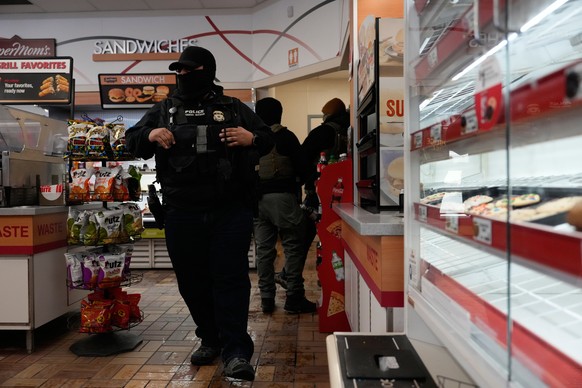 ICE agents make use of the facilities at a gas station, Monday, Jan. 19, 2026, in St. Paul, Minn. (AP Photo/Yuki Iwamura)
Immigration Enforcement Minnesota