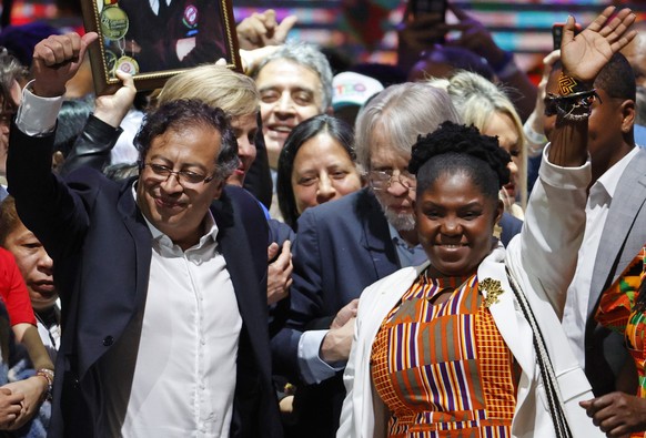 epa10023400 President-elect of Colombia Gustavo Petro (L) celebrates with his vice presidential candidate Francia Marquez (R) during an event at the Movistar Arena in Bogota, Colombia, 19 June 2022. T ...
