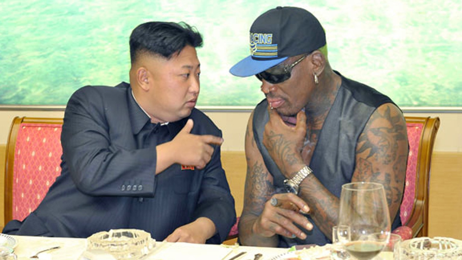 In this undated photo published on Sept. 7, 2013, on the homepage of North Korea&amp;#039;s Rodong Sinmun newspaper, North Korean leader Kim Jong Un, left, talks with former NBA player Dennis Rodman d ...