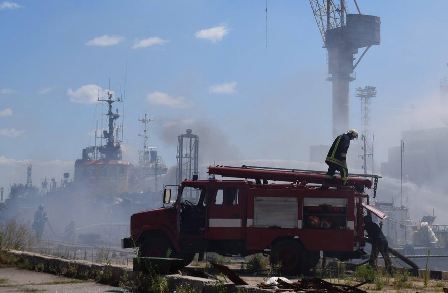 epa10088775 A handout photo released by the Odesa City Hall Press Office on 23 July 2022 shows firefighters working to put out a fire in a sea port of Odesa, southern Ukraine. Ukrainian authorities on ...