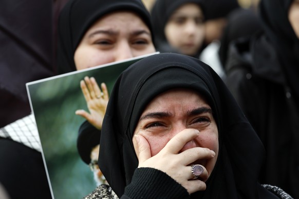 KEYPIX - epa12787753 Hezbollah supporters cry during a gathering in solidarity with the Islamic Republic of Iran in the Dahieh suburb of Beirut, Lebanon, 01 March 2026. Hundreds of Hezbollah supporter ...