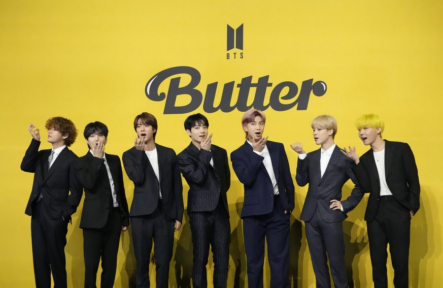 FILE - Members of South Korean K-pop band BTS, V, SUGA, JIN, Jung Kook, RM, Jimin, and j-hope from left to right, pose for photographers ahead of a news conference to introduce their new single &quot; ...