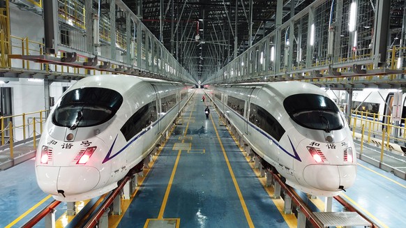 epa10411246 A photo taken with a drone shows bullet trains parked at the Changsha West bullet train maintenance base in Changsha, Hunan Province, China, 17 January 2023. Staff members at the Changsha  ...