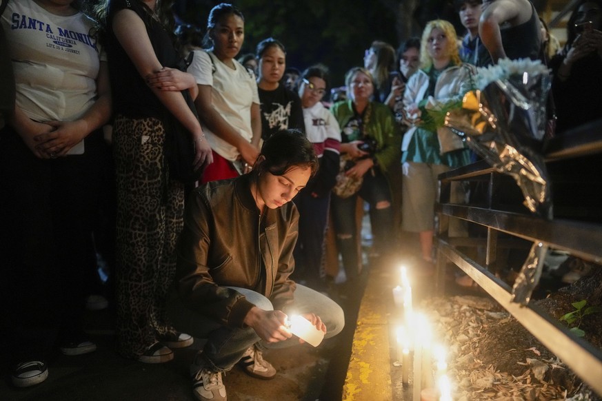 Fans light candles outside the hotel where former One Direction singer Liam Payne was found dead after he fell from a balcony in Buenos Aires, Argentina, Wednesday, Oct. 16, 2024. (AP Photo/Natacha Pi ...