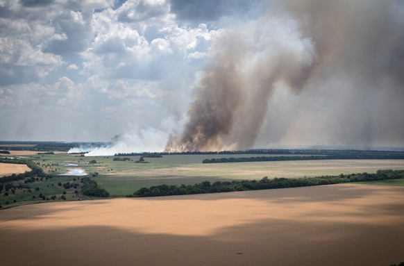 Smoke raises from the front lines where fierce battle is going between Ukrainian and Russian troops, farmer fields in the foreground, in the Dnipropetrovsk region, Ukraine, Monday, July 4, 2022. (AP P ...