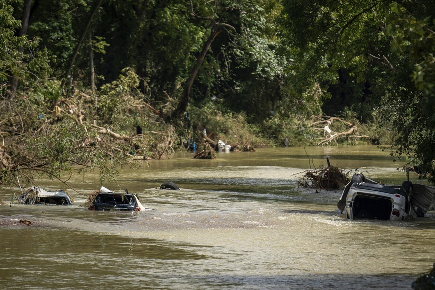 Vehicles are submerged in Trace Creek a sa result of severe weather in Waverly, Tenn., Sunday, Aug. 22, 2021. The downpours rapidly turned the creeks that run behind backyards and through downtown Wav ...