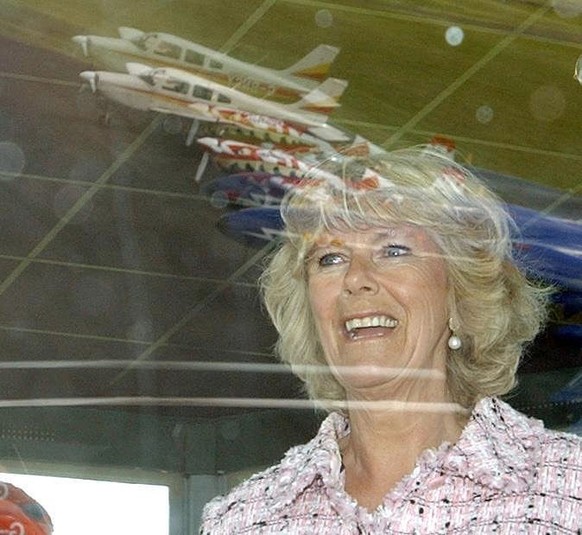 CIRENCESTER, ENGLAND - MAY 18: (NO UK SALES FOR 28 DAYS) TThe Duchess of Cornwall watches an acrobatic air display with husband Prince Charles, the Prince of Wales during their visit to Kemble Airfiel ...