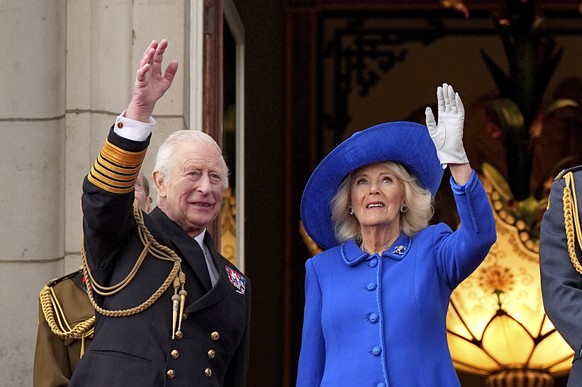 King Charles III and Queen Camilla on the balcony of Buckingham Palace to view the fly past featuring the Royal Air Force&#039;s Red Arrows after a military procession marking the 80th anniversary of  ...