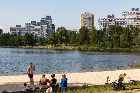 Temperatures Rise In Kyiv A family rests by the lake as temperatures soar in Northern Kyiv, the capital of Ukraine on May 14, 2023. Residents of Kyiv often use Dnipro waters and its lakes to rest and  ...